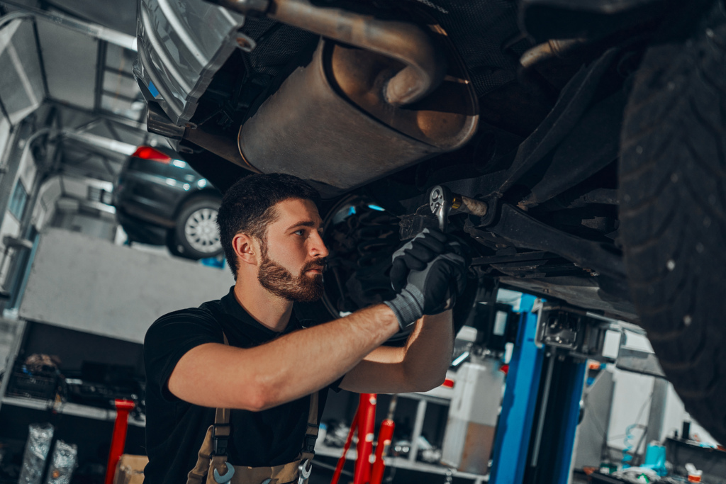 Person working on suspension under a car